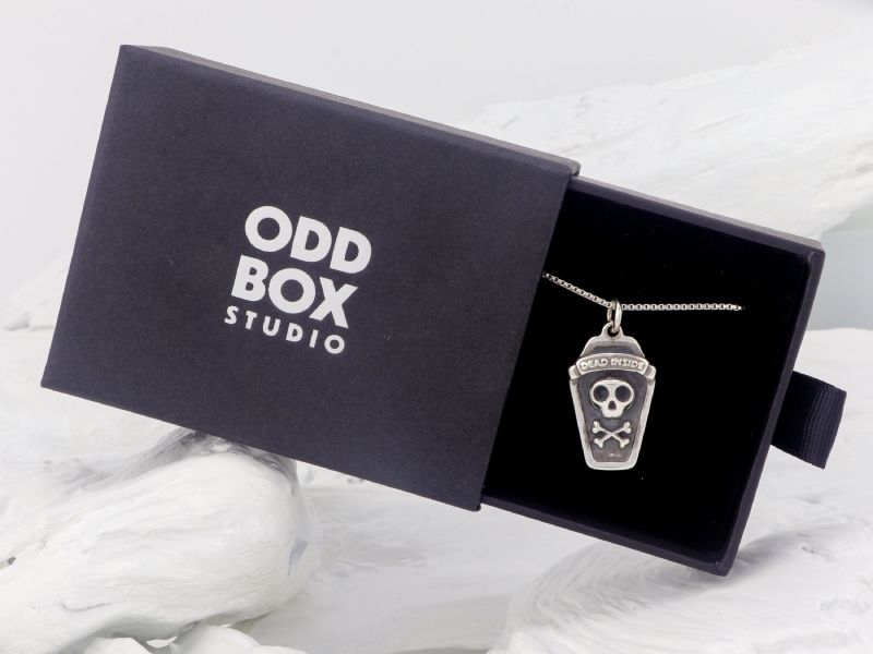 The Dead Inside pendant nestled in a black Oddbox Studio gift box